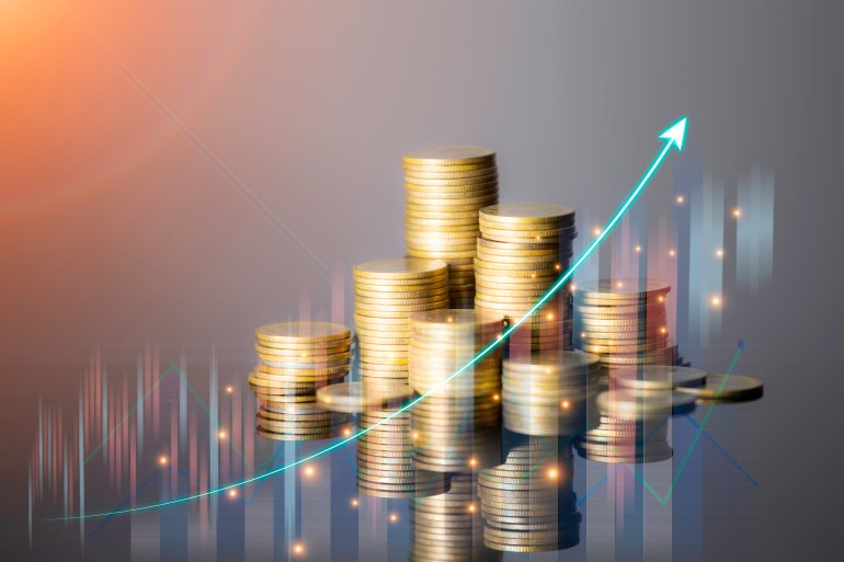 Coins are laid out in graph.Business success concept wealth stock investment.Business in the digital age. ...