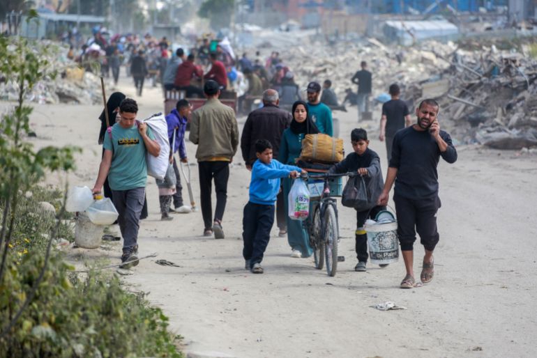 05-7-1744108536-1 Palestinians leave Beit Hanun in the northern Gaza Strip with their belongings, heading towards Gaza City following Israeli evacuation orders on March 19, 2025. The Israeli military dropped leaflets warning residents of what it called "combat areas" in the north and south of the besieged Palestinian territory, after Israel resumed air strikes following a ceasefire breakdown. (Photo by Bashar TALEB / AFP)
