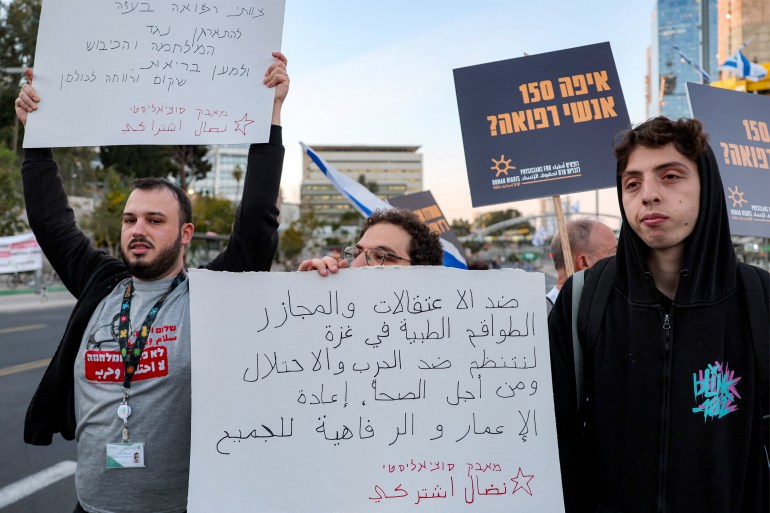 08-1-1743937795 Demonstrators raise placards as they gather during an anti-government protest against the death of Gaza aid workers outside the Israeli Defence Ministry headquarters in central Tel Aviv on April 5, 2025. Israeli forces launched a ground offensive in Gaza City, the military said on April 4, after renewed military operations in March ended a short-lived truce in its war with Hamas. Israel has since expanding its operations pushed to seize territory in the Gaza Strip in what it said was a strategy to force militants to free hostages still in captivity. (Photo by Jack GUEZ / AFP)