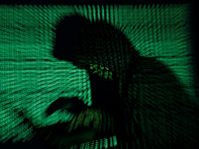 0a8d71cb-89be-43ea-b390-e7460142288e-2 A hooded man holds a laptop computer as cyber code is projected on him in this illustration picture taken on May 13, 2017. Capitalizing on spying tools believed to have been developed by the U.S. National Security Agency, hackers staged a cyber assault with a self-spreading malware that has infected tens of thousands of computers in nearly 100 countries. REUTERS/Kacper Pempel/Illustration TPX IMAGES OF THE DAY
