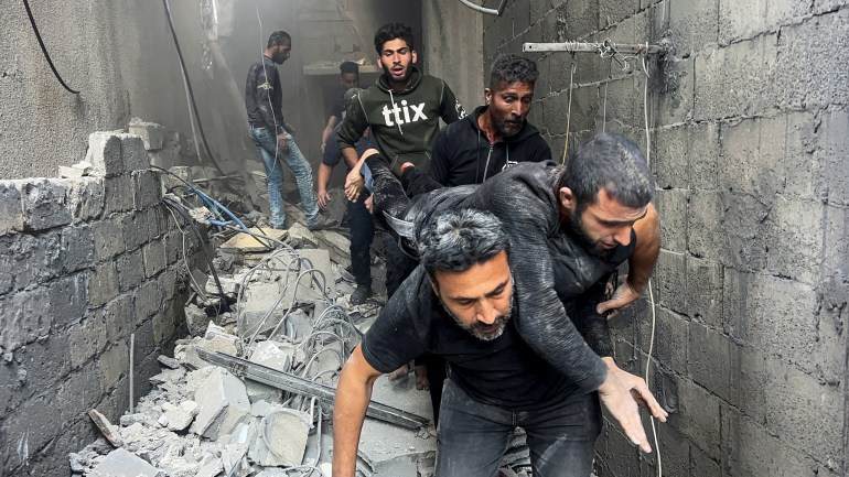 2aza-1744354966 Palestinians carry an injured man at the site of an Israeli strike on a house in Shejaia, in Gaza City, April 10, 2025. REUTERS/Stringer TPX IMAGES OF THE DAY