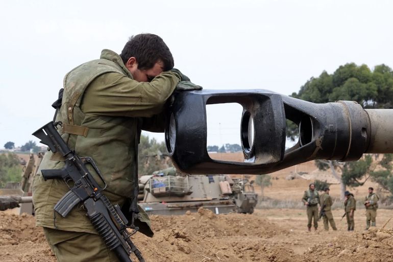 645d98a-1732657297 TOPSHOT-ISRAEL-PALESTINIAN-CONFLICT-PHOTO ESSAY TOPSHOT - An Israeli soldier rests his head on the gun barrel of a self-propelled artillery howitzer as Israeli soldiers take positions near the border with Gaza in southern Israel on October 9, 2023. One month after Israel was wracked by Hamas attacks, life has been upended for both the Palestinians and Israel after it launched a war of reprisal in the Gaza Strip. The October 7 attacks by Hamas militants who stormed across from Gaza and struck kibbutzim and southern Israeli areas killed 1,400 people, mostly civilians, and deeply scarred the nation. The health ministry in Hamas-run Gaza says nearly 9,500 have been killed, two-thirds of them women and children, and mostly civilians. (Photo by JACK GUEZ / AFP) (Photo by JACK GUEZ/AFP via Getty Images)