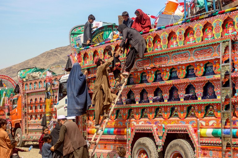 afghanistan-pk3-1744137899 Afghan refugees deported from Pakistan disembark a truck upon their arrival at a makeshift camp near the Afghanistan-Pakistan border in Torkham, Nangarhar province on April 7, 2025. Islamabad announced at the start of March that 800,000 Afghan Citizen Cards (ACC) would be cancelled -- the second phase of a deportation programme which has already forced 800,000 undocumented Afghans across the border. (Photo by AFP)