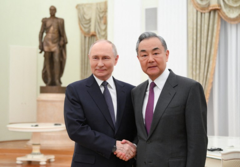 afp-1929476397_1a103c-1743516166 In this pool photograph distributed by the Russian state agency Sputnik, Russia's President Vladimir Putin meets with Chinese Foreign Minister Wang Yi at the Kremlin in Moscow on April 1, 2025. (Photo by Grigory SYSOYEV / POOL / AFP)