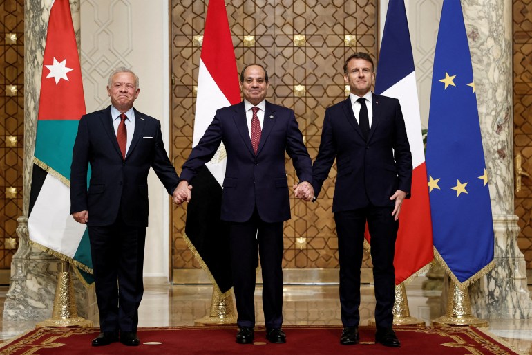 afp_67f3d6c5d00d-1744033477 TOPSHOT - (L to R) Jordan's King Abdullah II, Egypt's President Abdel Fattah al-Sisi, and French President Emmanuel Macron shake hands while posing together for a picture during a trilateral summit to discuss the situation in Gaza at the Presidential Palace in Cairo on April 7, 2025.