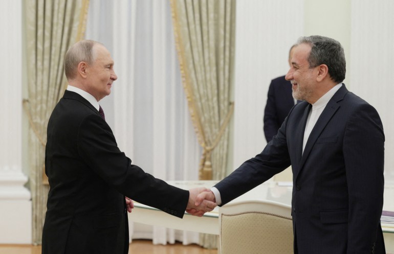 afp_680122f8efd7-1744904953 TOPSHOT - In this pool photograph distributed by the Russian state agency Sputnik, Russia's President Vladimir Putin shakes hands with Iran's Foreign Minister Abbas Araghchi during a meeting at the Kremlin in Moscow on April 17, 2025. (Photo by Gavriil Grigorov / POOL / AFP)