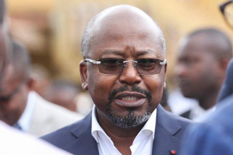 Gabonese Prime Minister Alain-Claude Bilie-By-Nze looks on in the Adzougou district near Mount Miyele visiting the repair works of the urban roads in the city of Oyem on January 22, 2023 on the eve of the departure of the Tropicale Amissa Bongo cycling race. (Photo by Steeve JORDAN / AFP)