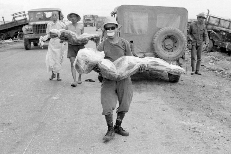 ap359644186756-1745930711 Civilians carry bodies of relatives, July 11, 1972, killed in an ambush along Route 1, south of Quang Tri, Vietnam, two months ago. A Buddhist priest accompanies them here to a simple grave along roadside. (AP Photo)