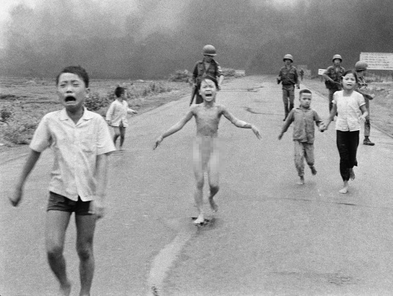 ap7206080850-1745930746 Vietnam Napalm 1972 South Vietnamese forces follow after terrified children, including 9-year-old Kim Phuc, center, as they run down Route 1 near Trang Bang after an aerial napalm attack on suspected Viet Cong hiding places on June 8, 1972. A South Vietnamese plane accidentally dropped its flaming napalm on South Vietnamese troops and civilians. The terrified girl had ripped off her burning clothes while fleeing. The children from left to right are: Phan Thanh Tam, younger brother of Kim Phuc, who lost an eye, Phan Thanh Phouc, youngest brother of Kim Phuc, Kim Phuc, and Kim's cousins Ho Van Bon, and Ho Thi Ting. Behind them are soldiers of the Vietnam Army 25th Division. (AP Photo/Nick Ut)
