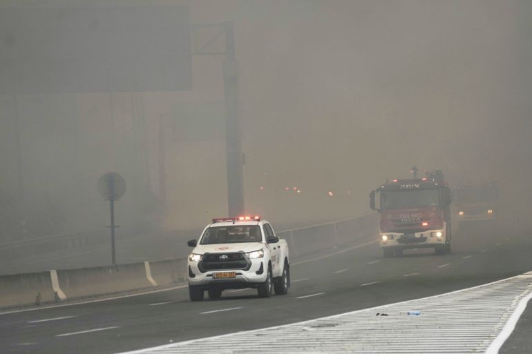 ap_68125557f1b99-1746031960 Israeli fire department drives through smoke from a burning fire on the freeway near Jerusalem, Wednesday, April 30, 2025. (AP Photo/Mahmoud Illean)