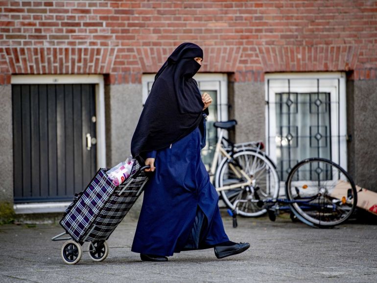 c38ef7f2-19a0-4159-ba95-b4b561bf87fb epa07749858 (FILE) - A nikab veiled woman pulls her shopping bag along a street in Rotterdam, Netherlands, 29 July 2019 (Issued on 31 July 2019). Facial coverings will be banned in the Netherlands, from public transport, schools, hospitals and government buildings as of 01 August 2019. The Dutch Islamic political party NIDA has announced a plan to pay for all fines received by wearers of the burka and niqab when the new law comes into effect next. EPA-EFE/ROBIN UTRECHT