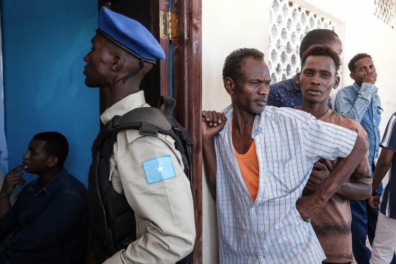 d8a7d984d8b5d988d985d8a7d9844-1744734609 A Somali security officer monitors access as men queue for a voter registration exercise in Mogadishu on April 15, 2025. Somalia on April 15, 2025 launched voter registration in the capital Mogadishu for the first time in over 50 years, a step towards universal suffrage ahead of presidential elections scheduled for 2026 in the volatile East African nation. (Photo by Hassan Ali Elmi / AFP)
