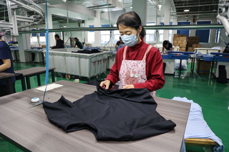 An employee works on a T-shirt production line at a clothing factory in Binzhou, in eastern China's Shandong province on April 22, 2025. (Photo by AFP) / China OUT / CHINA OUT / CHINA OUT