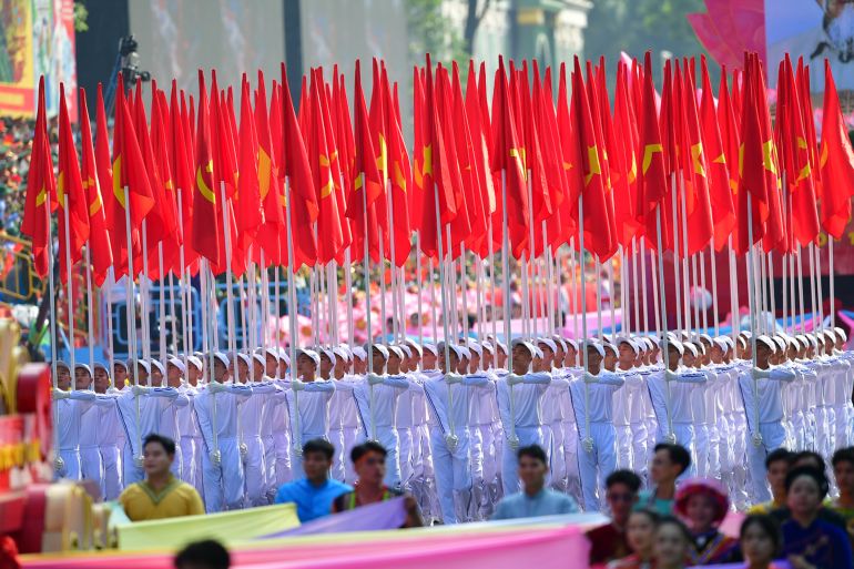 epa_6811aefeeac0-1745989374 epa12064002 People holding flags march during a parade marking the 50th anniversary of the Liberation of the South and National Reunification Day, in Ho Chi Minh City, Vietnam, 30 April 2025. Vietnamese Reunification Day is observed annually on 30 April. EPA-EFE/STRINGER