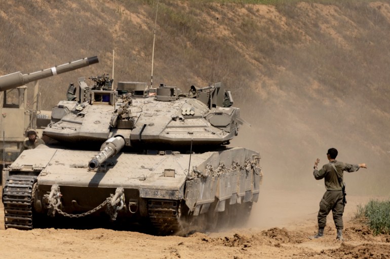 getty-859151254_b89e7d-1743279935 SOUTHERN ISRAEL, ISRAEL - MARCH 18: An Israeli soldier directs a tank near the border with the Gaza Strip on March 18, 2025 in Southern Israel, Israel. Hundreds were killed in Gaza in Israel's overnight strikes across the territory, according to the Hamas-run health ministry. They were the largest strikes since a ceasefire started on January 19; that truce reached the end of its first phase and negotiations on beginning its second phase had appeared to falter. (Photo by Amir Levy/Getty Images)