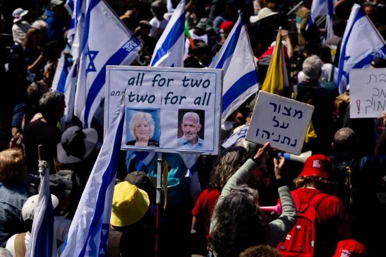getty_67f565dab3-1744135642 JERUSALEM, ISRAEL - MARCH 23: Protesters hold signs with photos of attorney general Gali Baharav Miara and Israel's intelligence Director Ronen Bar during a protest against the Israeli government outside the Prime Minister's office on March 23, 2025 in Jerusalem. Israelis are taking to the streets calling for a new ceasefire in Gaza and to protest against what they consider to be an attack on the country's democracy by the rightwing coalition of Benjamin Netanyahu's government. (Photo by Amir Levy/Getty Images)