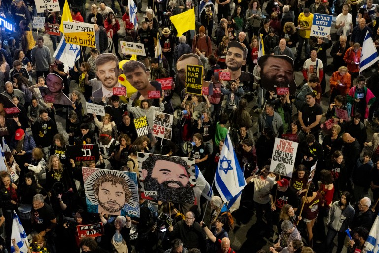 TEL AVIV, ISRAEL - MARCH 29: Protesters hold photos of hostages held in the Gaza Strip during a demonstration demanding the release of all hostages and against Israeli Prime Minister, Benjamin Netanyahu, and his government on March 29, 2025 in Tel Aviv. Anti-government protests have occurred here regularly in recent months, as Israelis press their government to negotiate for the return of the remaining hostages in Gaza. Activists have also been roiled by the government's continuing judicial overhaul and other policies they consider anti-democratic. (Photo by Amir Levy/Getty Images)
