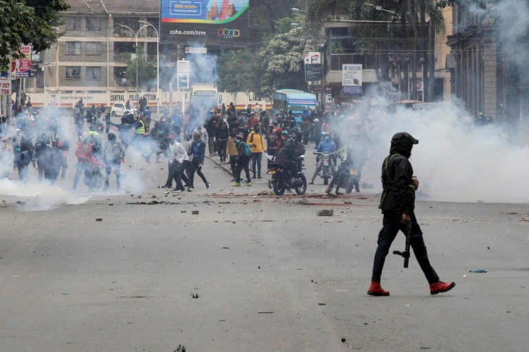 kenya3-1719856660 FILE PHOTO: A police officer walks after using tear gas to disperse protesters during a demonstration over police killings of people protesting against Kenya's proposed finance bill 2024/2025, in Nairobi, Kenya, June 27, 2024. REUTERS/Monicah Mwangi/File Photo