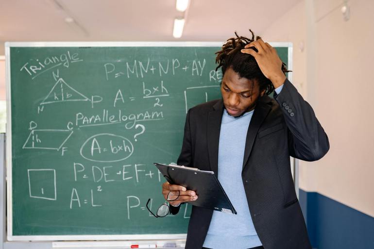 Man in Black Blazer Holding a Clipboard
