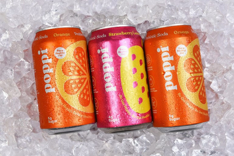 prebiotic-soda3-1744467100 IRVINE, CALIFORNIA - 6 SEPT 2024: Three cans of Poppi Prebiotic Soda on a bed of ice.