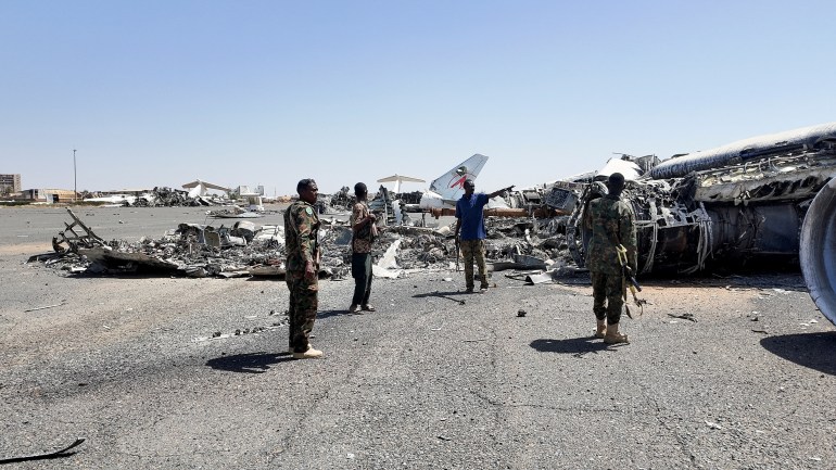 reuters_67fd5c8a-1744657547 Members of Sudanese army walk next to a destroyed plane's wreckage on the tarmac at Khartoum Airport, after the Sudanese army deepened its control over the capital Khartoum, from the Rapid Support Forces (RSF), in Khartoum, Sudan March 27, 2025. REUTERS/El Tayeb Siddig TPX IMAGES OF THE DAY