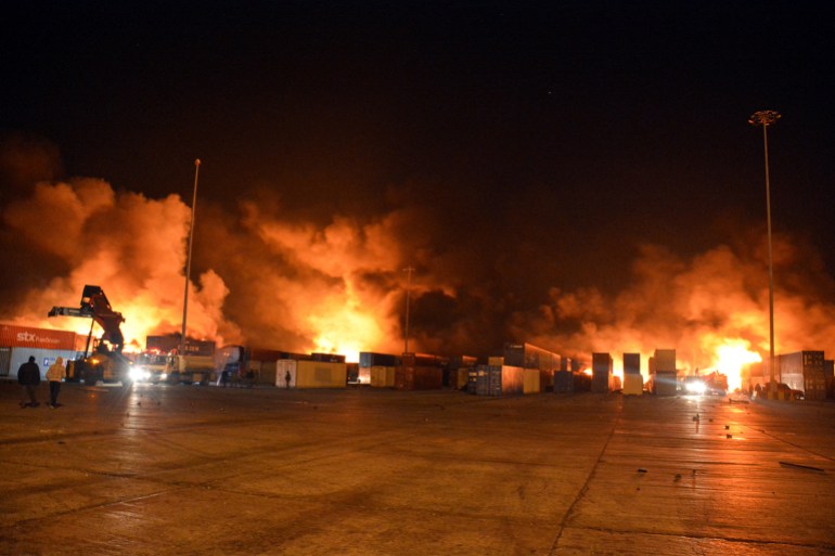 rts421ku Smoke rises after Syrian state media reported an Israeli missile attack in a container storage area, at Syrian port of Latakia