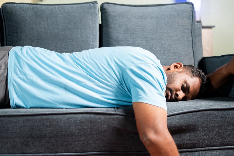 shutterstock_2081378542-1743785213 tired fat man sleeping on sofa at home - concept showing of resting, weekend holiday and exhausted due to overwork.; Shutterstock ID 2081378542; purchase_order: aj; job: ; client: ; other: