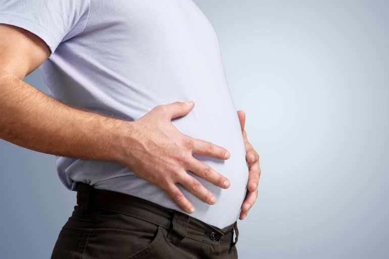 Fat man has excess fat, he is dieting and losing weight concept.; Shutterstock ID 2177188411; purchase_order: aj; job: ; client: ; other: