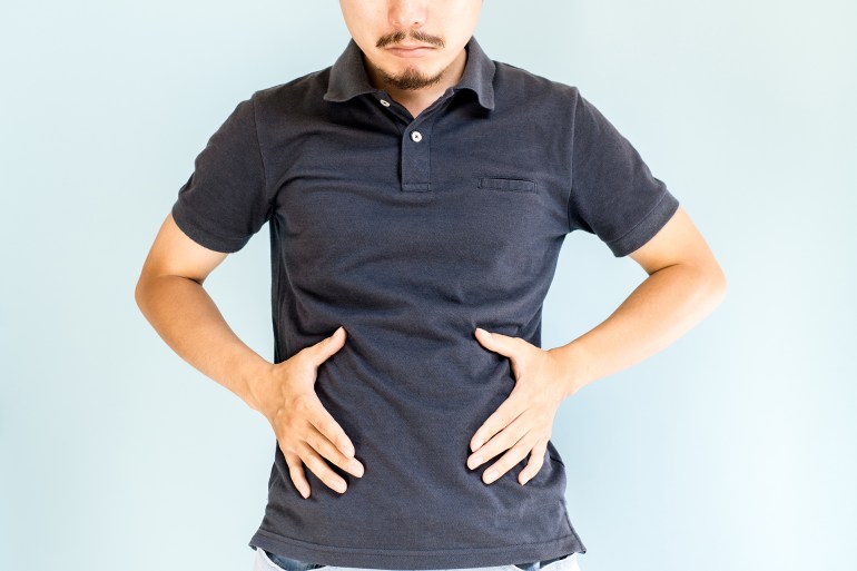 Man holding his waist; Shutterstock ID 476154622; purchase_order: aj; job: ; client: ; other: