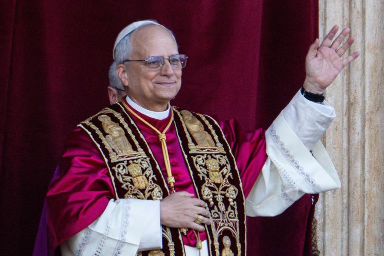 Newly elected Pope Leo XIV, left, formerly Cardinal Robert Francis Prevost, appears on the central loggia of St. Peter's Basilica at the Vatican shortly after his election as the 267th pontiff of the Roman Catholic Church, Thursday, May 8, 2025. (AP Photo/Domenico Stinellis)