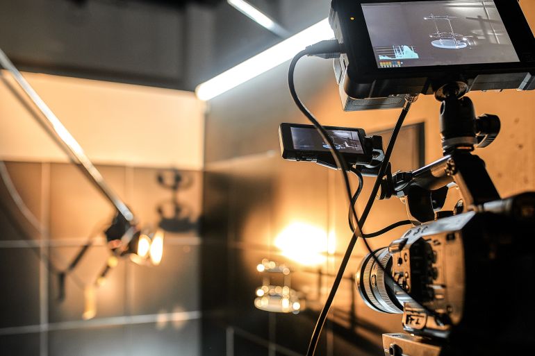 56ty-1746554798 Behind the scenes of filming movies and video products, setting up equipment for shooting video and sound. The concept of producing video content for social networks, TV and blogs ادوبي ستوك