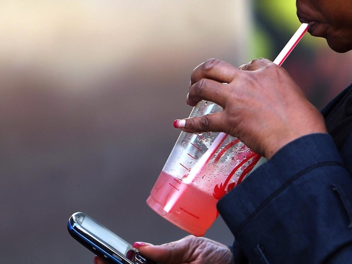 NEW YORK, NY - OCTOBER 17: A woman carries a large drink on October 17, 2013 in the Brooklyn borough of New York City. New York's Court of Appeal has agreed to hear New York City's appeal of a lower court ruling that blocked Mayor Michael Bloomberg's campaign to stop fast food restaurants from selling super-sized, sugary drinks. In a recent ruling, which dealt a blow to the campaign to improve the health of New Yorkers, the lower court said the city Board of Health exceeded its authority by putting a 16-ounce size limit on high-calorie sodas and soft drinks.