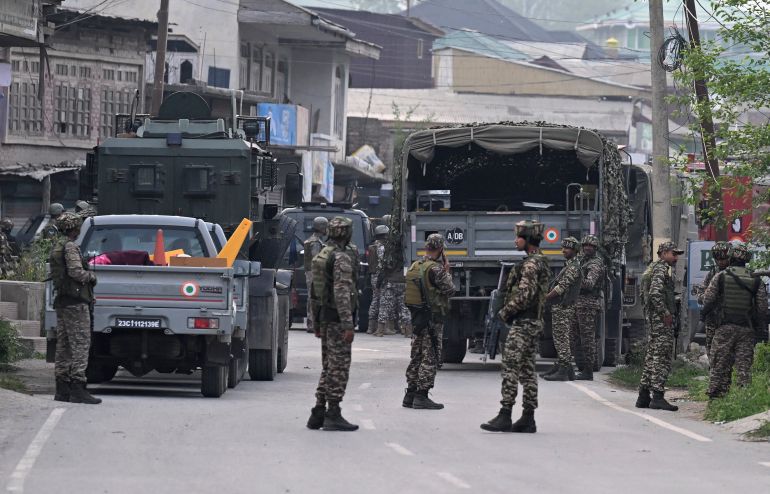 afp_681b04f54eb9-1746601205 Indian security personnel stand guard in Wuyan near Indian-administered Kashmir's main city of Srinagar on May 7, 2025.