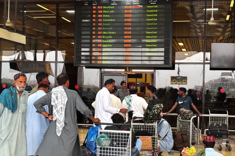 afp_681b0594acd0-1746601364 Passengers wait at Jinnah International Airport after all domestic and international flights were cancelled in Karachi on May 7, 2025.