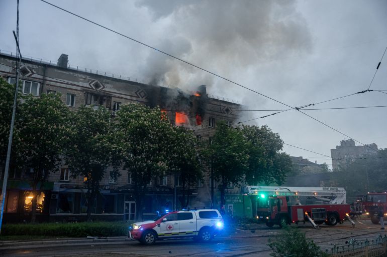 This handout photograph taken and released by the State Emergency Service of Ukraine on May 7, 2025, shows rescuers putting out a fire in a residential building following a Russian drone attack, in Kyiv, on May 7, 2025, amid the Russian invasion of Ukraine.