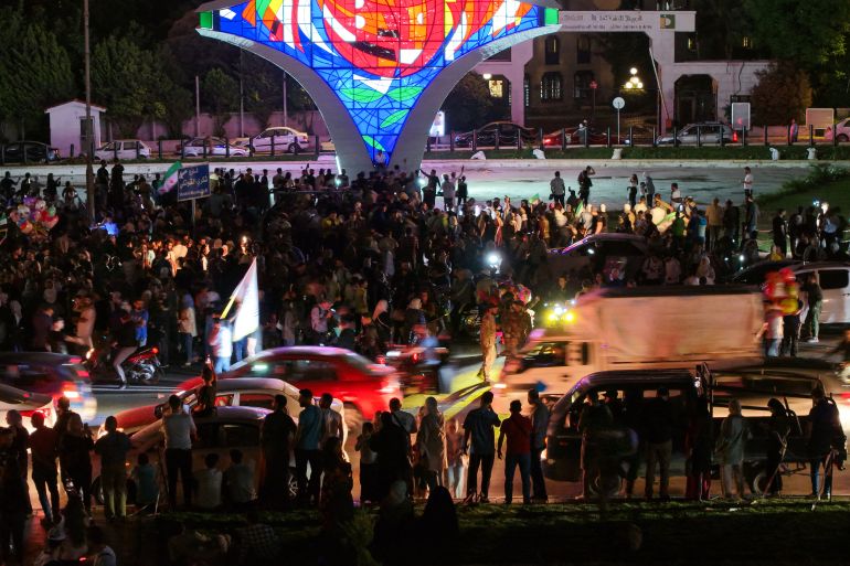 afp_6824605eee34-1747214430 People celebrate in Damascus' Omeyyad square after US President Donald Trump's decision to lift sanctions in Syria, on May 13, 2025.