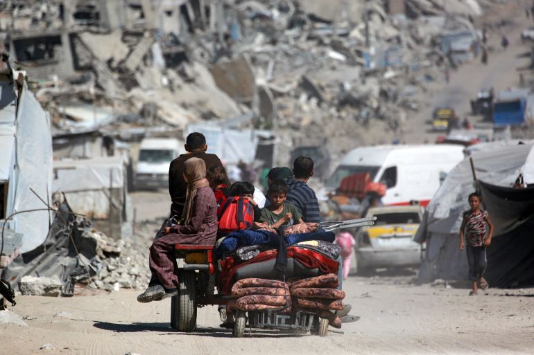 Palestinians transport their belongings as they flee Gaza City on May 16, 2025.