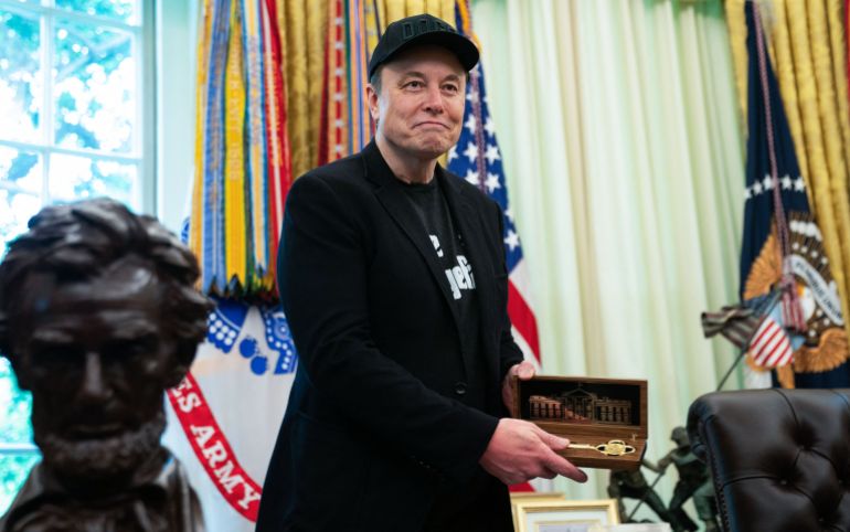 afp_683a8be07c64-1748667360 Elon Musk looks on as he holds a key given to him by US President Donald Trump during a news conference in the Oval Office of the White House in Washington, DC, on May 30, 2025.
