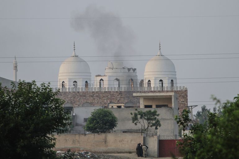 ap_681b047adbd50-1746601082 Local residents stand outside a mosque of an Islamic seminary partially damaged by a suspected Indian missile attack, outskirts of Bahawalpur, Pakistan, Wednesday, May 7, 2025. (AP Photo/Asim Tanveer)