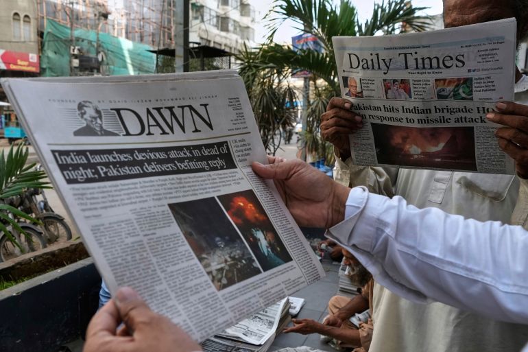 ap_681b052644d83-1746601254 People read morning newspapers leading with the story of India firing missiles into Pakistani territory, in Karachi, Pakistan, Wednesday, May 7, 2025. (AP Photo/Fareed Khan)