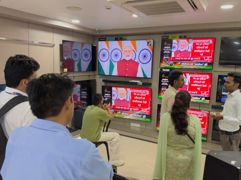 ap_682241546554c-1747075412 Indians watch the live telecast of Indian Prime Minister Narendra Modi's speech on television screens, in Prayagraj, in the northern Indian state of Uttar Pradesh, India, Monday, May 12, 2025. (AP Photo/Rajesh Kumar Singh)
