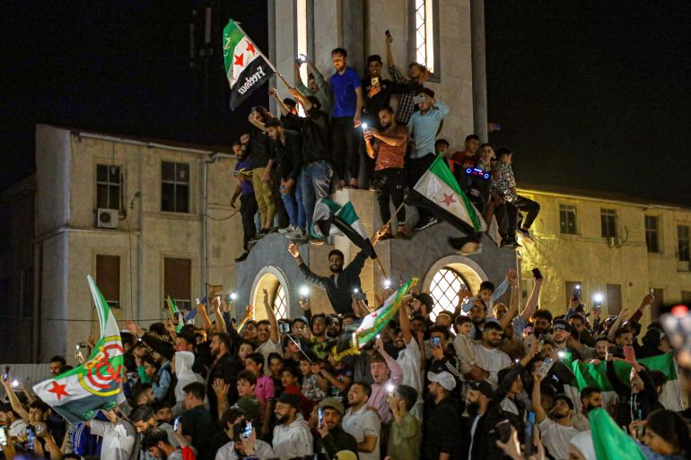 ap_682460b315c2e-1747214515 Syrians celebrate after U.S. President Donald Trump announced plans during his visit to Saudi Arabia to ease sanctions on Syria and normalize relations with its new government, in Homs, Syria, late Tuesday, May 13, 2025.(AP Photo/Omar Albam)