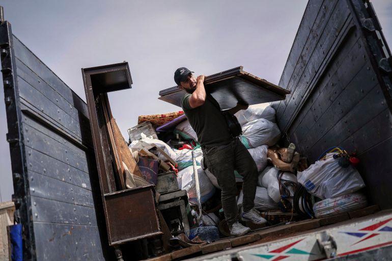 ap_683075ffce307-1748006399 A Syrian man unloads a truck as around 60 displaced families, supported by an NGO, return to their village after more than five years in the Atmeh camps near the Syrian-Turkish border, in Kafr Sijna, south of Idlib, Syria, Sunday, May 18, 2025. (AP Photo/Ghaith Alsayed)