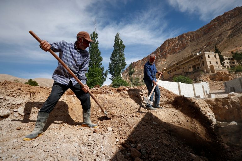 ap_68307625a3e8f-1748006437 Residents work on rebuilding their properties damaged during the war in Ein el-Fijeh, Barada Valley, Syria, Thursday, May 8, 2025. (AP Photo/Omar Sanadiki)