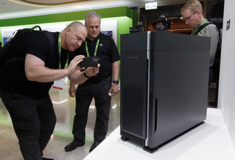 ap_68344c7e56e5e-1748257918 People take a photo of Nvidia Supermicro ARS-55NW (inside the case) during the Computex 2025 exhibition in Taipei, Taiwan, Wednesday, May 21, 2025. (AP Photo/Chiang Ying-ying)