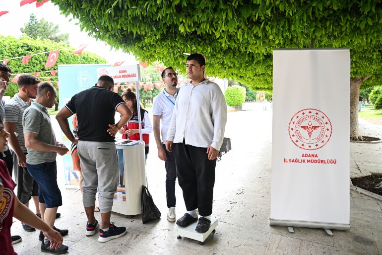 ADANA, TURKIYE - MAY 14: Health officials measure citizens' body mass index (BMI) at booths set up in the city as part of the Health Ministry's "Know Your Ideal Weight, Live Healthy" campaign, launched simultaneously nationwide, on May 14, 2025 in Adana, Turkiye. The initiative aims to assess the BMI of approximately 250,000 people over two months. (Photo by Eren Bozkurt/Anadolu via Getty Images)