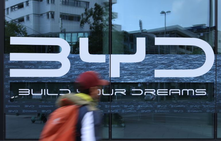 getty_683593ad77-1748341677 BERLIN, GERMANY - MAY 23: A man walks past a dealership of Chinese electric car manufacturer BYD on May 23, 2025 in Berlin, Germany. BYD has overtaken Tesla in electric car sales in Europe, landing at the number 10 spot for sales in April and Tesla sliding to 11th place. Skoda and Volkswagen were at the top of the list. (Photo by Sean Gallup/Getty Images)