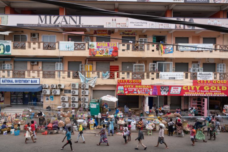 ACCRA, GHANA - OCTOBER 20: Pedestrians stride past shops that have been shut down as part of a protest by the Ghana Union of Traders Association (GUTA) on October 20, 2022, in Accra, Ghana. Traders in the Ghanaian capital, Accra, closed their shops on Wednesday on the first day of a five-day action to protest against Ghana’s forex challenges and the cost of living. (Photo by Ernest Ankomah/Getty Images)