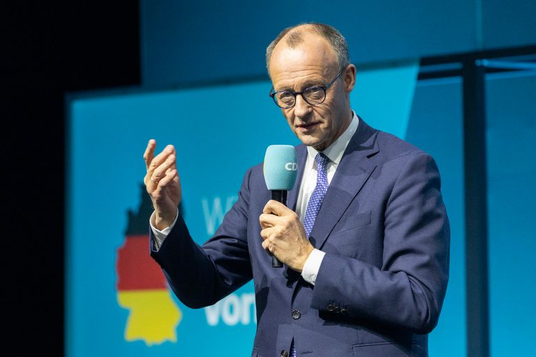 gettyimages-2200907494-1740674623 BERLIN, GERMANY - FEBRUARY 20: Friedrich Merz, chancellor candidate of Germany's Christian Democrats (CDU/CSU), speaks to voters during an election campaign tour stop on February 20, 2025 in Berlin, Germany. Merz is currently leading in polls ahead of snap federal parliamentary elections scheduled for February 23. (Photo by Maja Hitij/Getty Images)