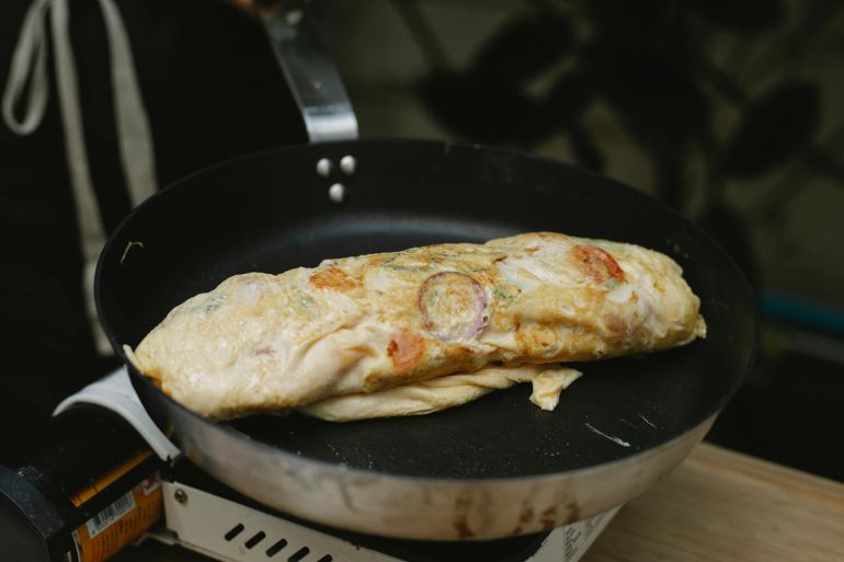 pex6294361-1747071877 Appetizing egg roll frying on pan